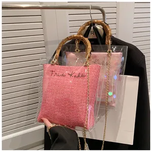 Detail of transparent PVC bag with bamboo handle and pink Frida Kahlo inner pouch