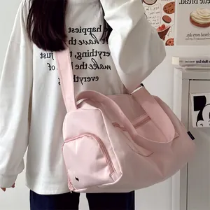 Detail view of pink multifunctional gym bag with adjustable straps and zipper pockets