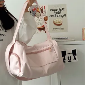 Detailed view of pink fitness bag with shoe compartment and waterproof fabric texture