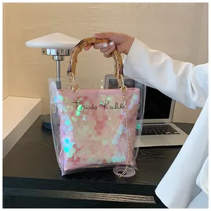 Detail of pink sequin bag with bamboo handle and transparent PVC outer layer