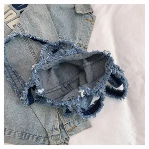 Top view of denim tote bag showing spacious interior and frayed edge detailing
