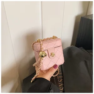 Détail du mini sac boîte rose matelassé avec fermoir fleur dorée et ajustable