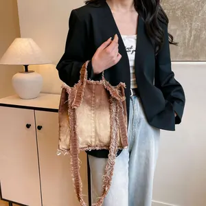 Brown gradient denim tote bag with frayed edges and oversized casual shoulder design