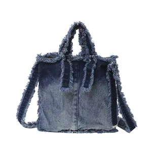 Denim tote bag with frayed edges and blue gradient wash in a minimalist design