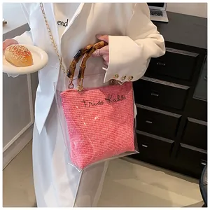 Close-up of a pink woven inner bag with Frida Kahlo text and stylish bamboo handle