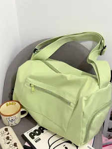 Detail of avocado green sports bag with side compartment on a chair