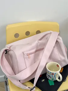 Detail of light pink large capacity gym bag with zipper pockets and wide shoulder strap