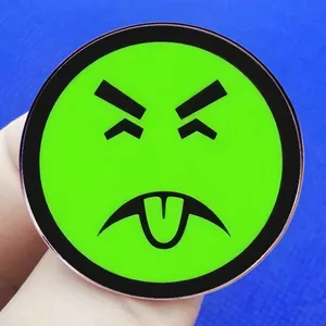 Fluorescent green cartoon emoji badge with angry expression and black metal rim