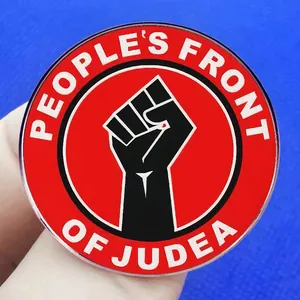 Round People's Front of Judea enamel badge with power fist symbol on blue background