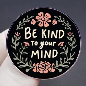 Enamel pin featuring floral motifs and BE KIND TO YOUR MIND inspirational quote