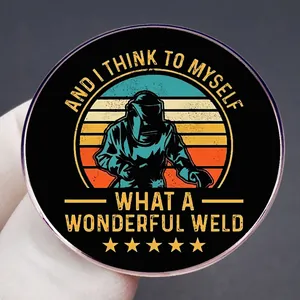 Funny welding worker cartoon enamel pin with 'What a Wonderful Weld' text on black background