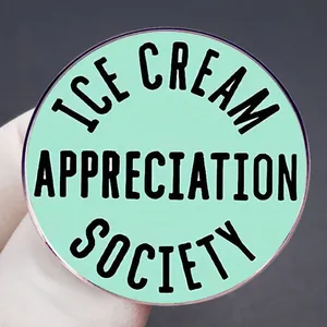 Mint green Ice Cream Appreciation Society metal badge with bold black circular lettering