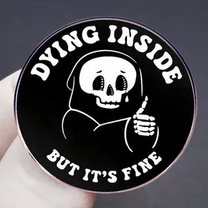 Round enamel badge featuring a cartoon reaper and Dying Inside text on a metal pin