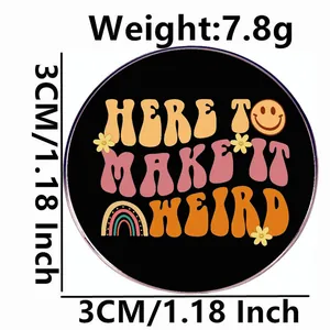 Retro circular enamel pin with Here to Make It Weird text and colorful pop art icons