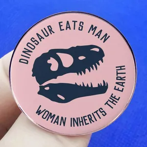 Pink enamel dinosaur skull brooch with humorous quote Dinosaurs eat man woman inherits earth