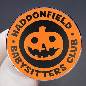 Haddonfield Babysitters Club enamel pin with Halloween pumpkin design and black text