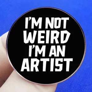 I'm Not Weird I'm An Artist slogan pin badge on a minimalist blue background