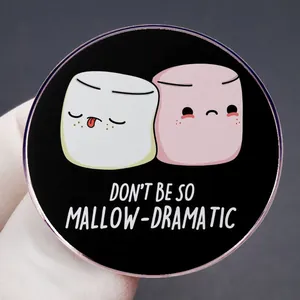 Round enamel pin featuring marshmallow cartoon characters with Mallow-Dramatic text