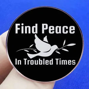 Find Peace In Troubled Times enamel pin featuring a white dove on black background