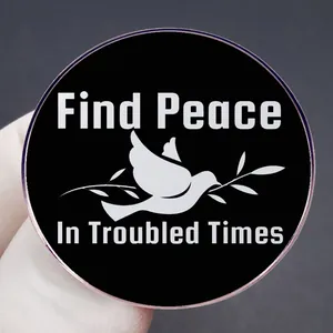 Find Peace In Troubled Times round pin badge with white dove on black background