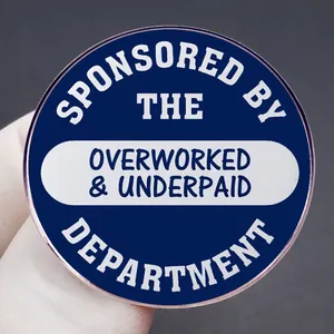 Enamel lapel pin with Sponsored by the Overworked and Underpaid Department text