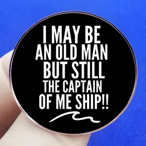 Old Man Captain brooch pin with white text on black round alloy metal badge