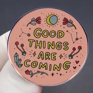 Round Good Things Are Coming brooch pin with colorful sun moon and floral hand-drawn icons