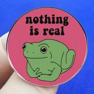 Funny green cartoon frog pin with nothing is real text on vibrant pink background