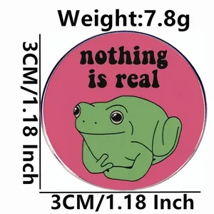 Green frog enamel pin with 'nothing is real' text, 1.18 inch round funny metal badge