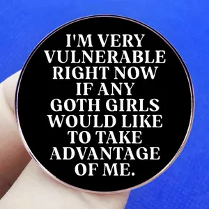 Gothic style circular metal badge with humorous white English text on black matte surface