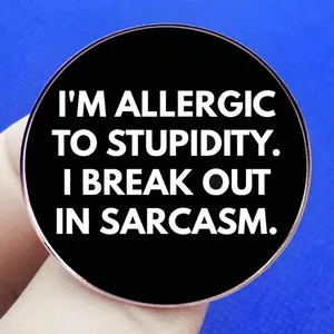 Funny black round brooch with Sarcasm quote in white lettering for clothing decor