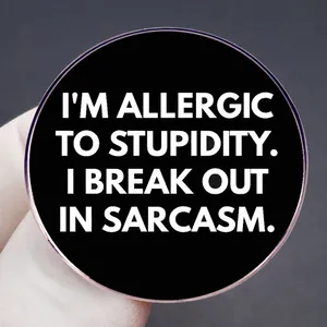 Black round brooch pin featuring I'm Allergic to Stupidity sarcasm quote for decoration