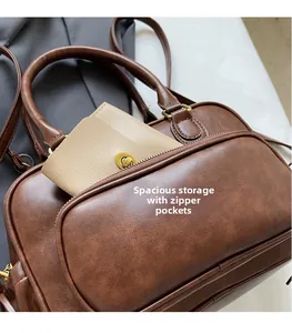 Close-up of vintage brown leather bag showing spacious storage and front zipper pocket
