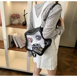 Detail view of a black star-shaped Ita bag with a transparent window for anime badges