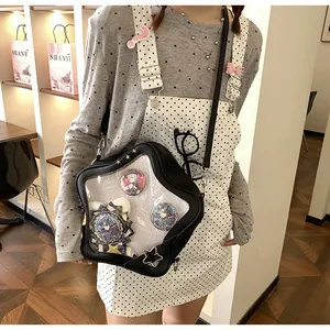 Detail of star-shaped ita bag with transparent window for pins on a crossbody model