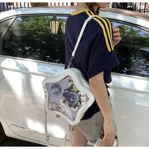 Detailed view of white star-shaped ITA bag with clear window for anime pins and badges