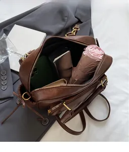 Brown faux leather bag interior showing capacity for phone, umbrella and wallet