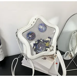 Detail of star-shaped ita bag featuring clear PVC window and metallic mesh for pins