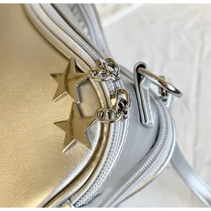 Macro shot of silver metallic PU leather bag with twin star-shaped metal zipper pulls