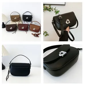 Detail view of heart-shaped metal buckle and various colors of stylish saddle bags