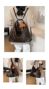 Detail of vintage dark brown faux leather convertible backpack with plush dog charm