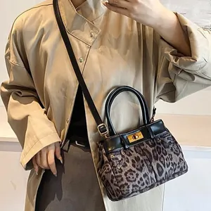 Fashionable leopard print Kelly style handbag for women with black leather trim and strap