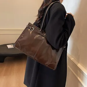 Vintage dark brown leather tote bag with adjustable strap for commuting and daily use