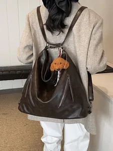 Retro brown leather large capacity backpack for women with metal zipper and plush charm