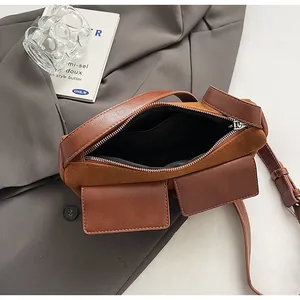 Detail of brown suede patchwork baguette bag showing zip closure and inner lining