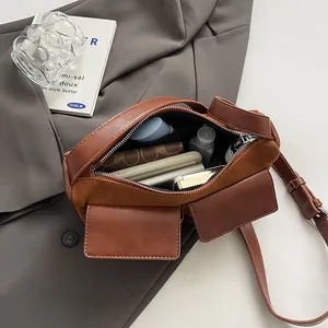 Brown faux leather and suede baguette bag showing spacious interior with daily essentials