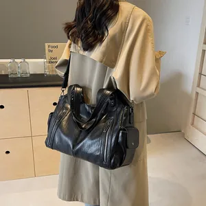 Large black glossy leather tote bag with stylish zipper pockets for daily commute