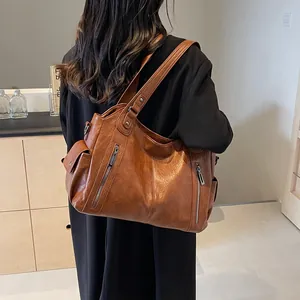 Brown oil-wax leather tote bag for women showing a stylish crossbody view in a room