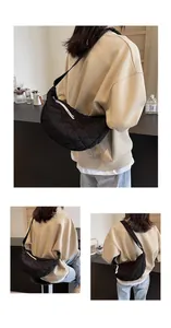Detailed views of black quilted crescent crossbody bag with adjustable wide shoulder strap