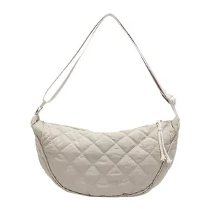 Minimalist beige quilted crescent crossbody bag with adjustable strap and casual style